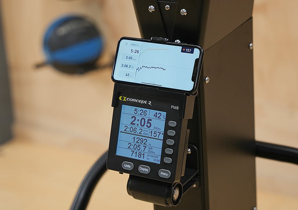 Close up of a smartphone being used with a Performance Monitor on the SkiErg